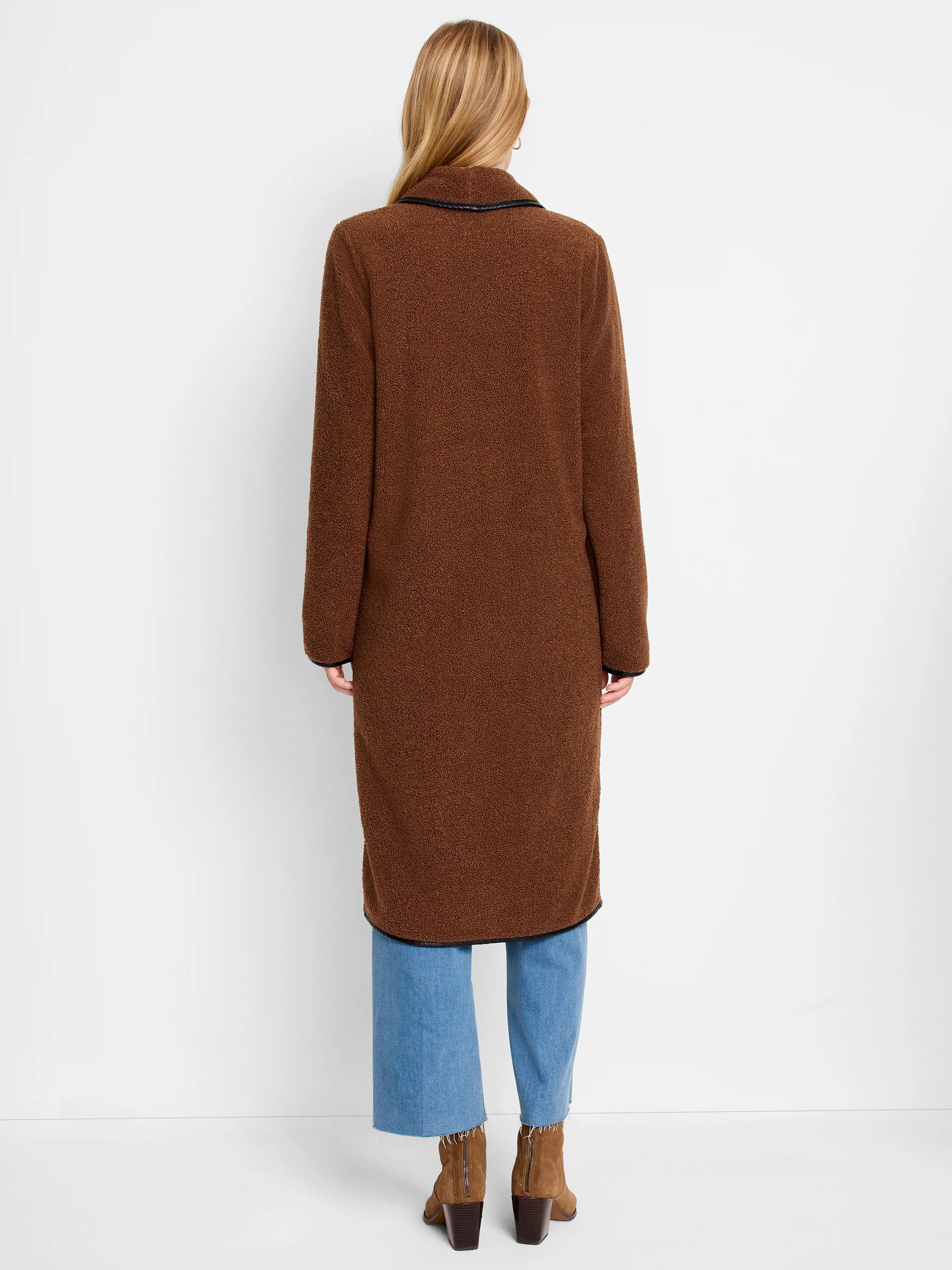 Long brown teddy coat with black trim on collar, cuffs, and hem. Model shown from behind.