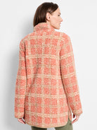 Peach and tan plaid sherpa jacket with a mock neck.