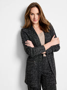 Black and white knit jacket with a dotty grid pattern and silver side zipper.