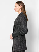 Black and white dotty grid knit jacket. Features lapels, a single button closure, and a visible zip detail.