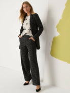 Black and white speckled grid-knit jacket, shown open.