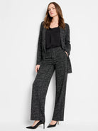 Black and white dotty grid knit jacket, worn open with matching pants.