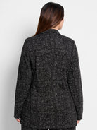 Black knit jacket with a white dotty grid pattern, shown from the back.