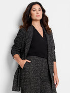 Black and white dotty grid knit jacket with a textured pattern.