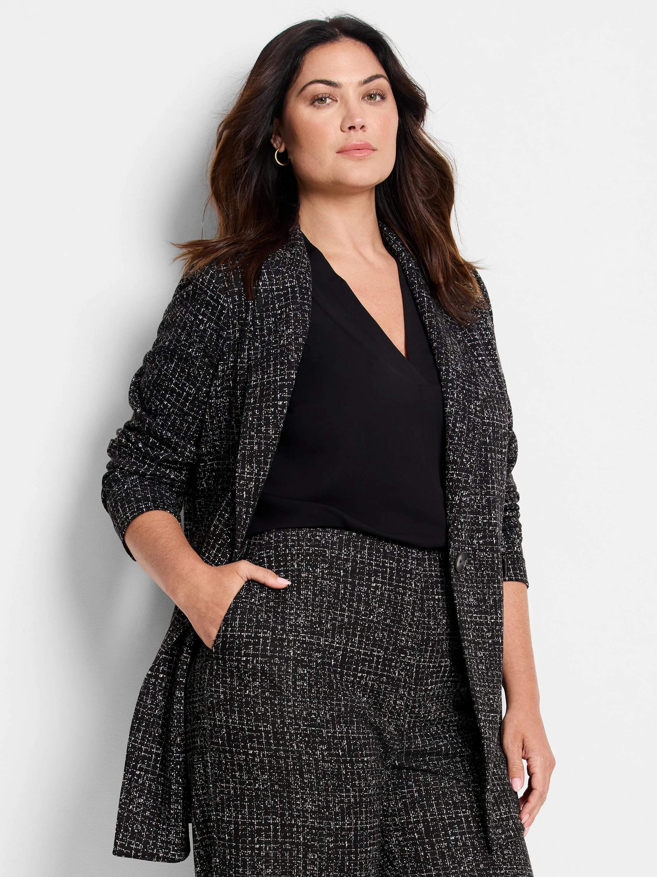 Black and white dotty grid knit jacket with a textured pattern.