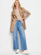 Tan, hip-length jacket with an open front and wide, draped collar. Appears soft.