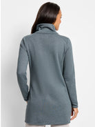 Muted blue-green heathered jacket, high funnel neck, long sleeves, tunic length. Model from behind.