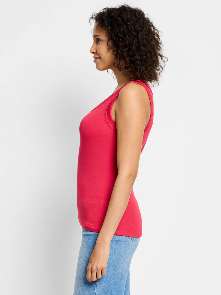Form-fitting red ribbed knit scoop tank top on a model, side view.