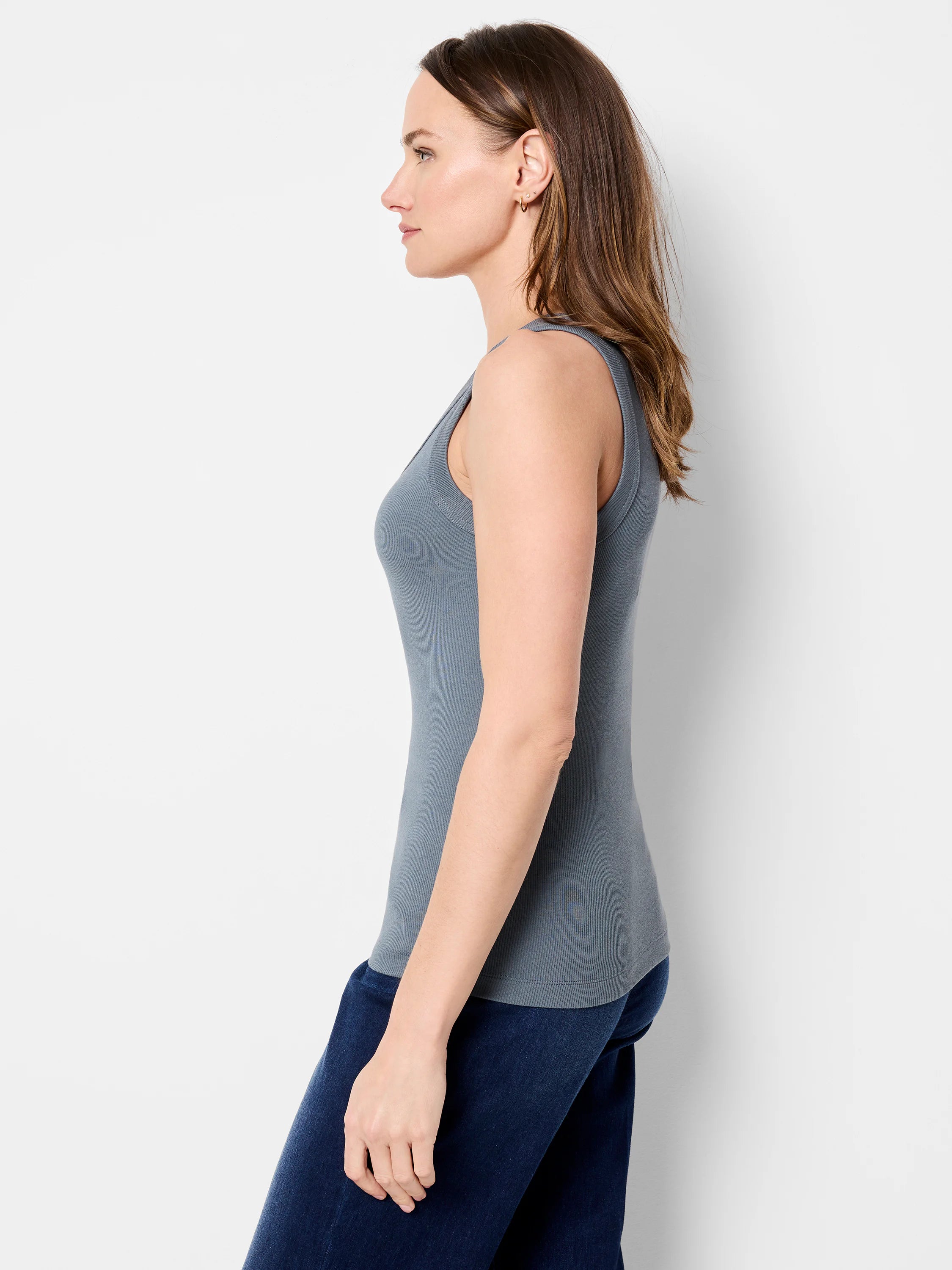 Fitted, muted blue-gray ribbed tank top on a model, shown in side profile.