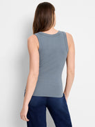 Blue-gray ribbed knit tank top, back view on model. Features a scoop neckline and close fit.