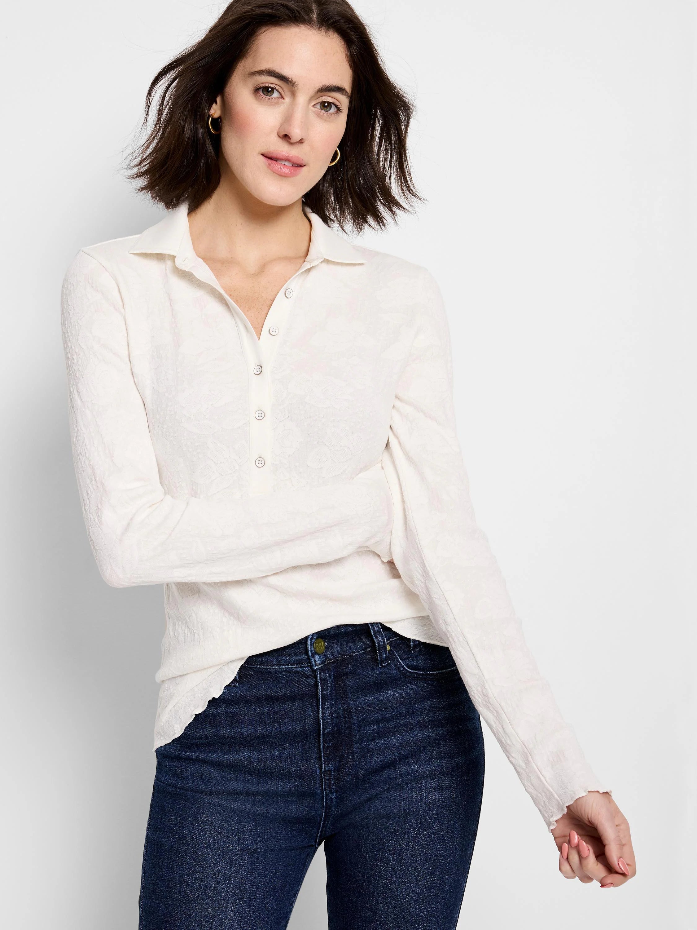 Cream lace knit collared top with a 5-button placket, long sleeves, and ruffled cuffs.