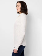 Off-white lace knit collared top with subtle floral texture, long sleeves, and wavy edges.