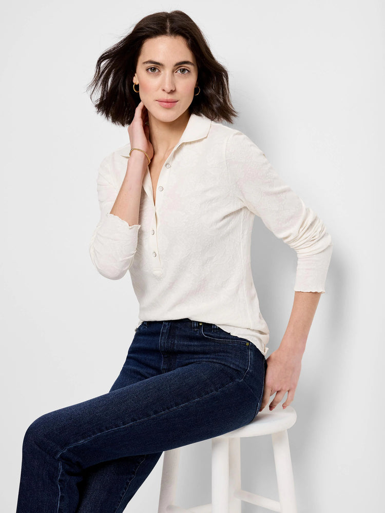 Cream lace knit collared henley top with long sleeves and ruffled cuffs.