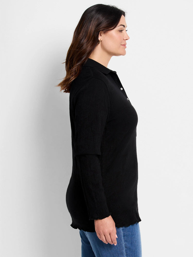 Black lace knit collared top with long sleeves, white buttons, and ruffled cuffs/hem.