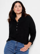 Black lace knit collared top with white buttons down the placket and ruffled cuffs.