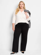 Cream lace knit collared top with 3-button placket, long sleeves, and scalloped cuffs and hem.