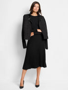 Black mixed media moto jacket with suede-like body, knit sleeves, asymmetrical zipper, and snaps.