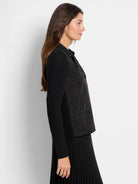 Black mixed media moto jacket with faux leather body, ribbed knit sleeves, asymmetrical zip, and zip pocket.