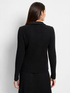 Black mixed media moto jacket with a ribbed knit body and a smooth collar, shown from the back.