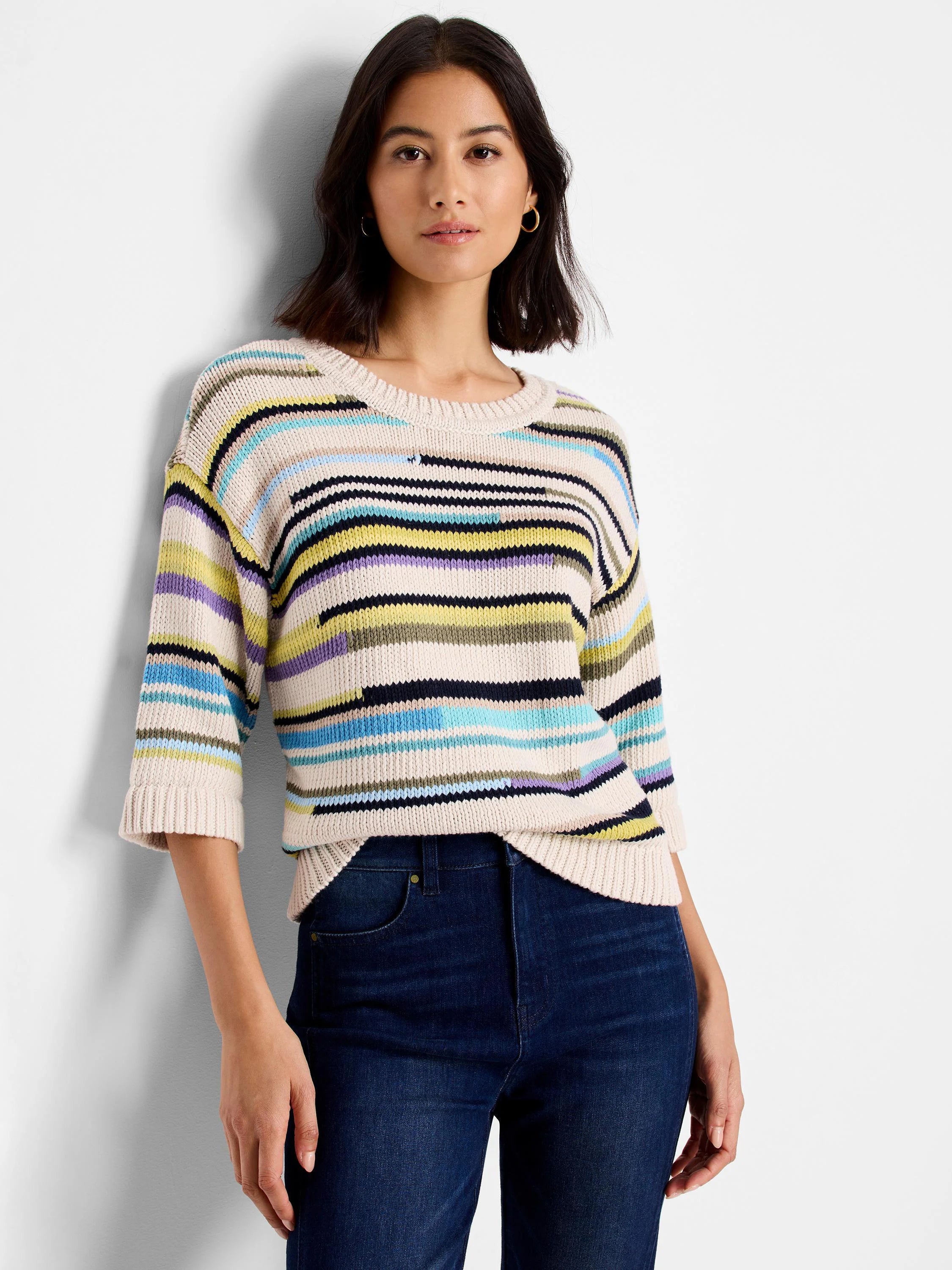 Ecru sweater with varied horizontal stripes in black, pale yellow, light blue, lavender, and olive. Features 3/4 sleeves.
