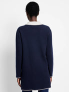 Navy knit jacket, back view, with light grey zig-zag trim on collar, cuffs, and hem. Long sleeves.