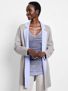 Light gray reversible jacket, periwinkle blue lapels & interior, with decorative white edge stitching.