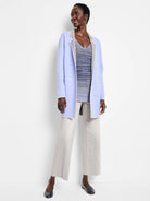 Periwinkle reversible jacket with gray lining, white scalloped stitching, and front patch pockets.