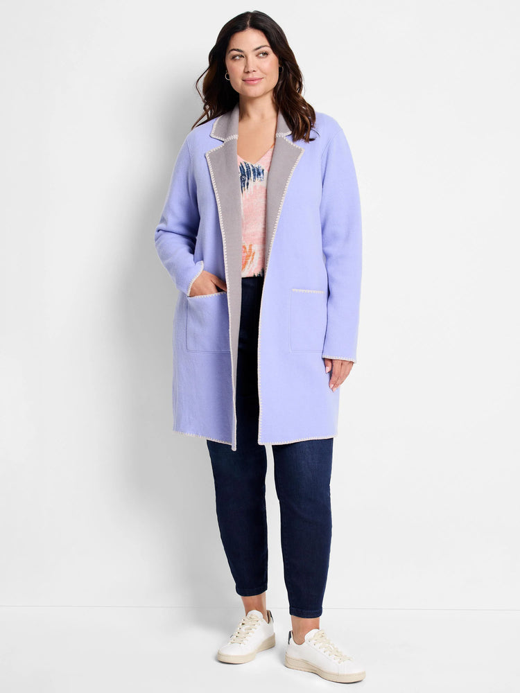 Lavender open-front knit jacket with grey notched lapels, trim, and patch pockets. Features decorative stitching. Reversible.