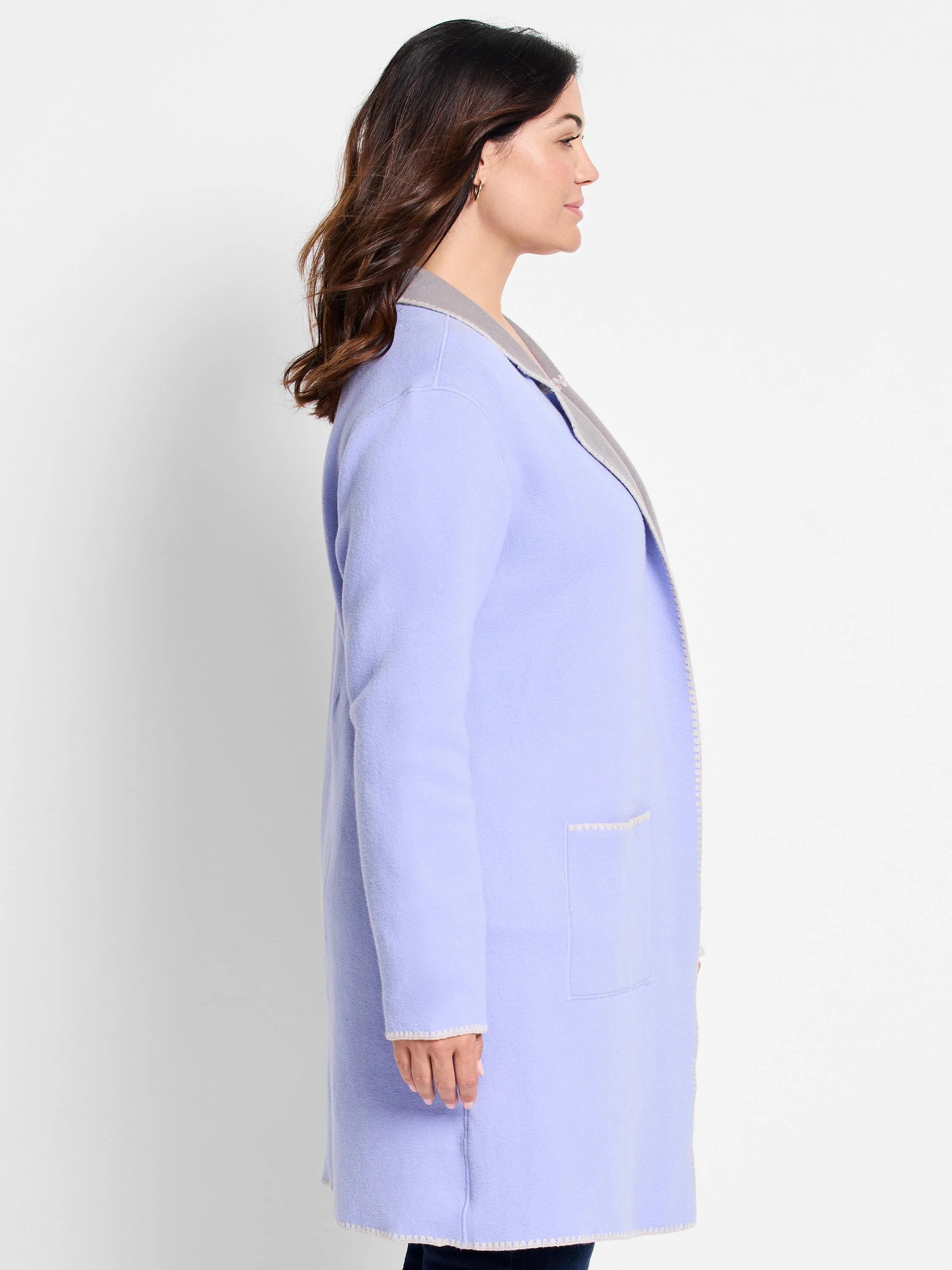 Reversible knit jacket: lavender body, gray collar. Cream zigzag trim on edges, cuffs, hem, and patch pocket. Open front.