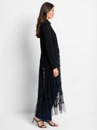 Black knit jacket with long, tiered sheer black tulle extending to the ankles.