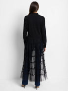 Black knit jacket with long sleeves and a high collar. Features a long, tiered, sheer black tulle lower section.