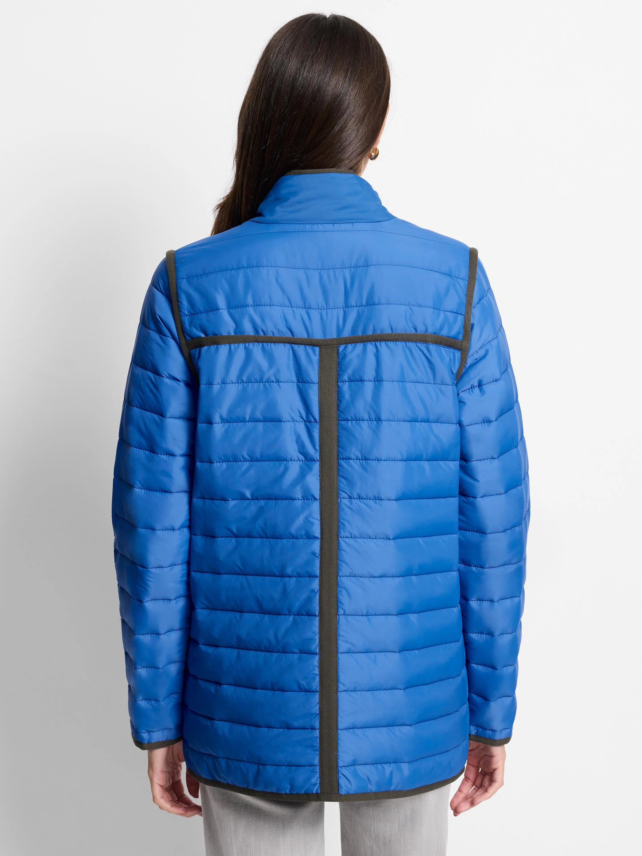 Back of a bright blue horizontally quilted jacket with dark grey trim on shoulders, T-shaped back, cuffs, and hem.