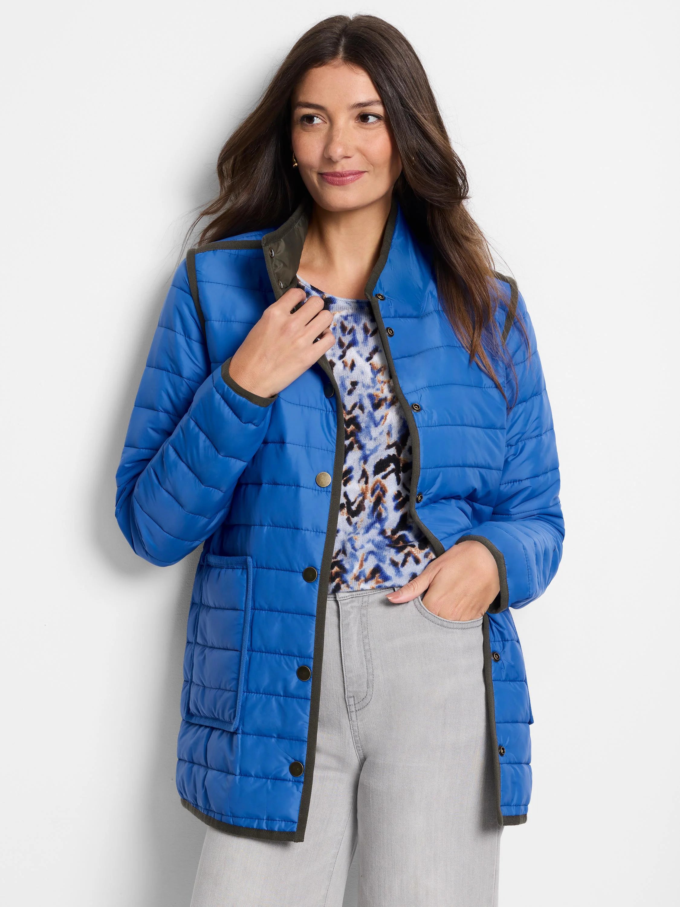 Bright blue quilted puffer jacket with olive green trim, snap buttons, and front patch pockets.