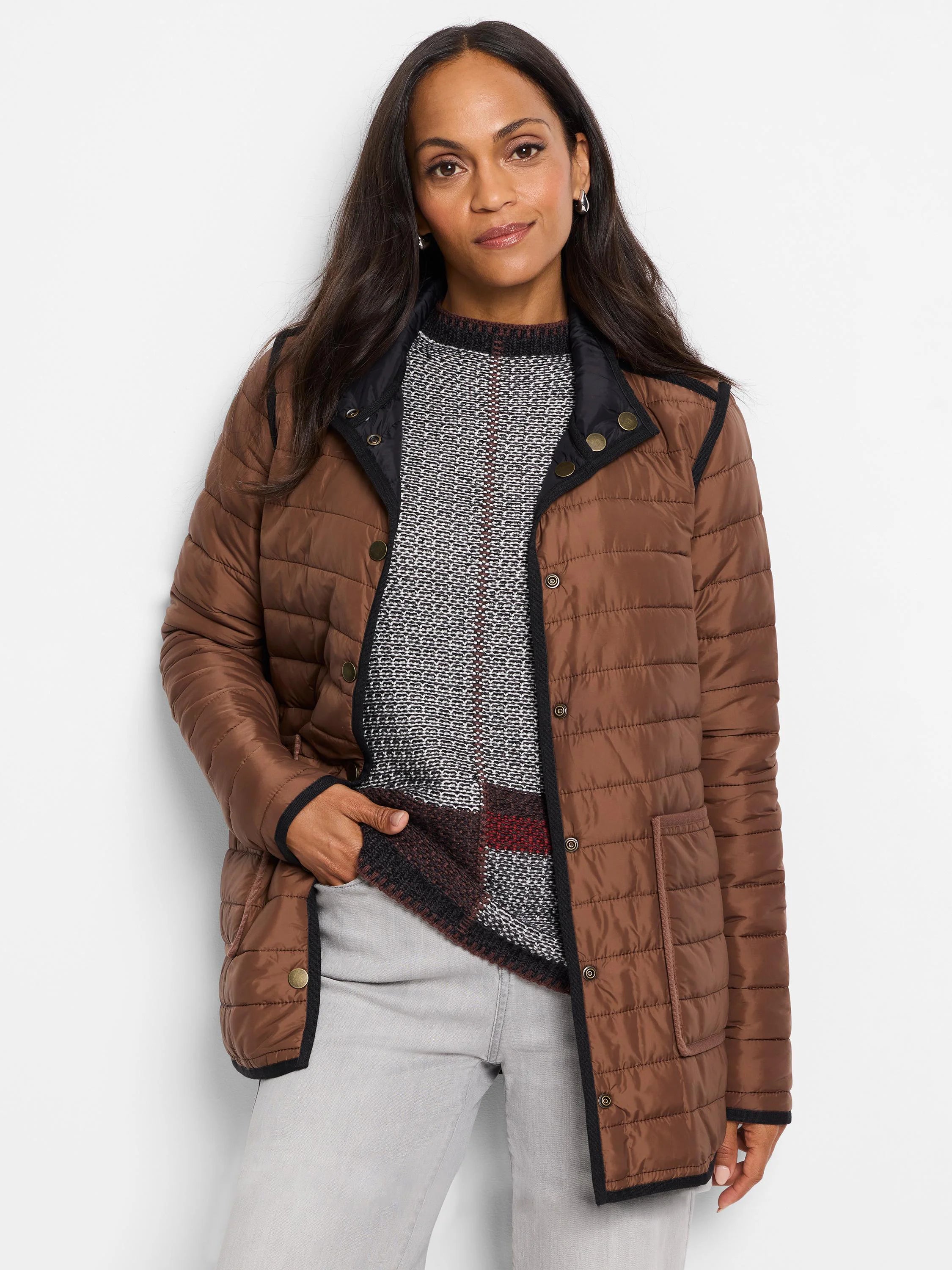 Reversible brown quilted puffer jacket with black trim and gold snap buttons.