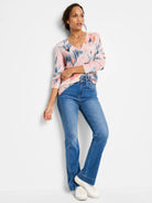 Pink waffle stitch V-neck sweater with abstract blue and coral pattern.