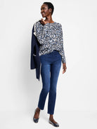 White long-sleeve sweater featuring a tossed paisley pattern in shades of blue and black.