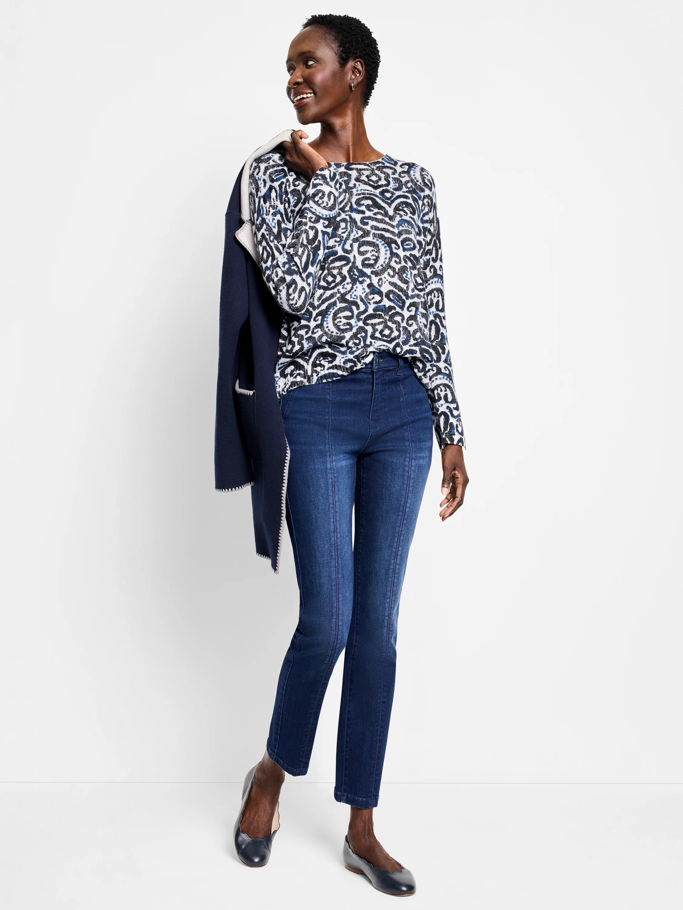 White long-sleeve sweater featuring a tossed paisley pattern in shades of blue and black.