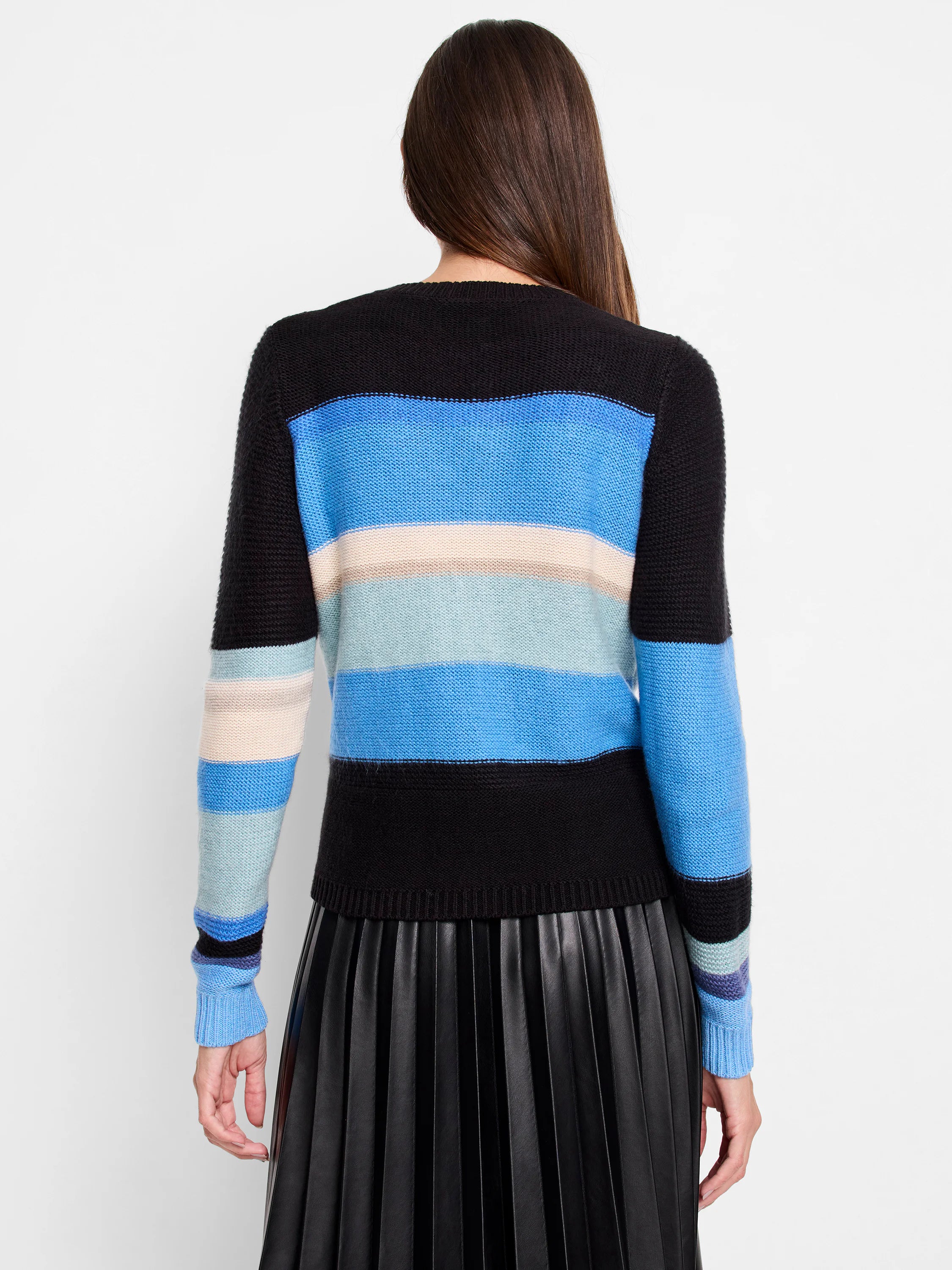 Black sweater with horizontal stripes: light blue, medium blue, bright blue, cream, and taupe. Shown from back.