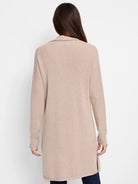 Long beige knit cardigan, back view on a model. Features long sleeves and side slits.