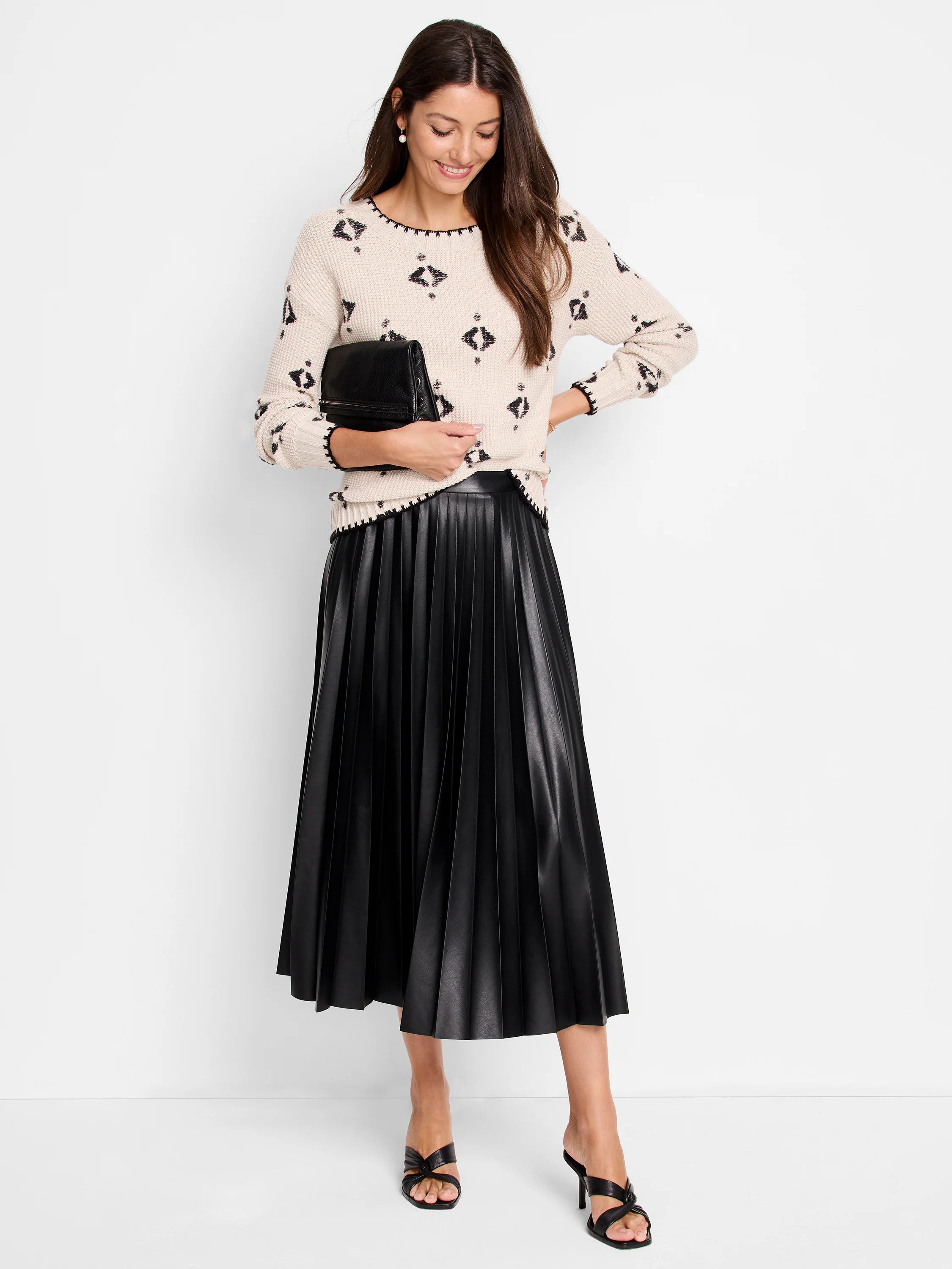 Cream knit sweater with black geometric pattern and black scalloped trim.