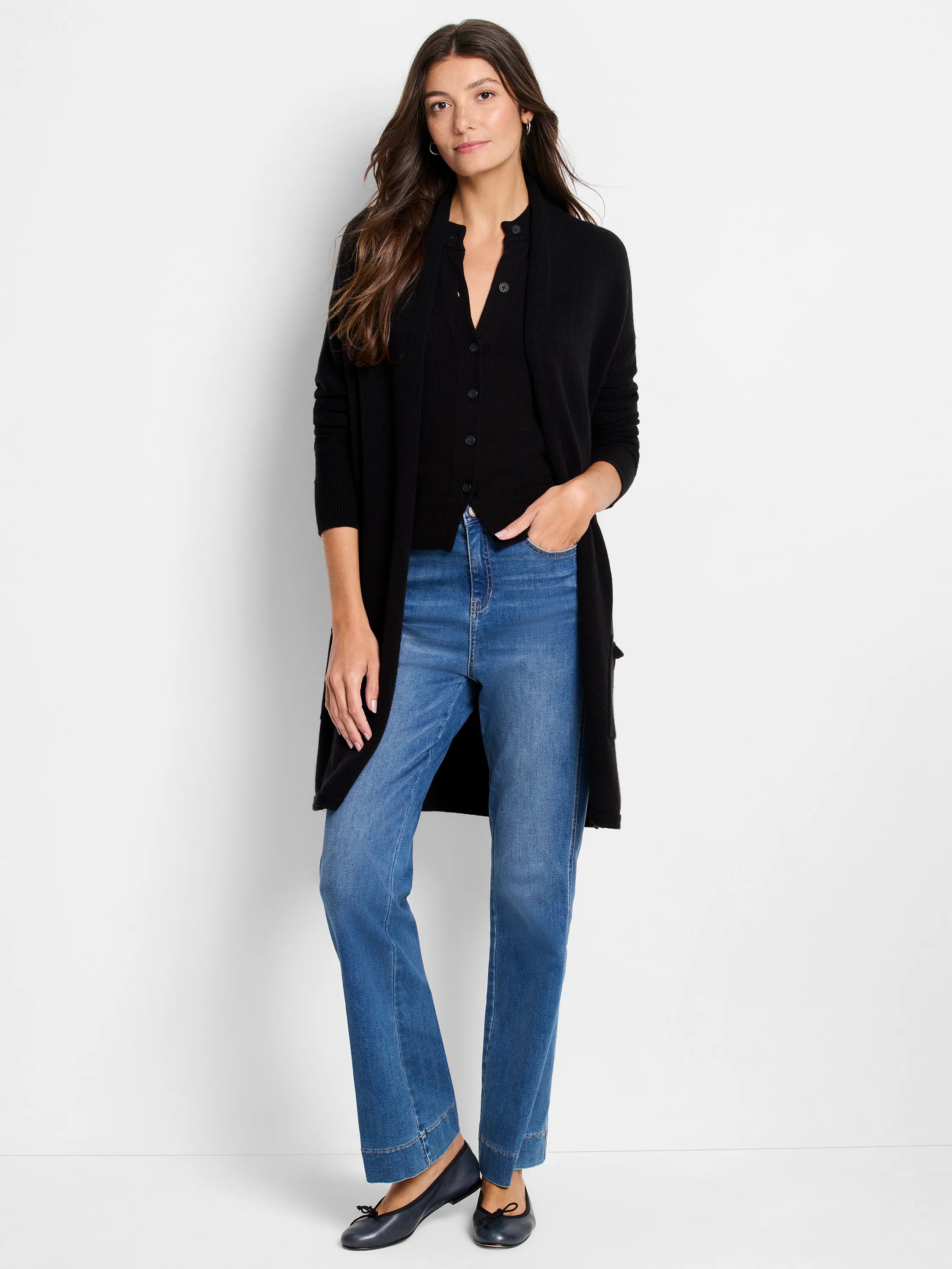 Black collared, button-front knit sweater with long sleeves. Styled under a long black open cardigan.