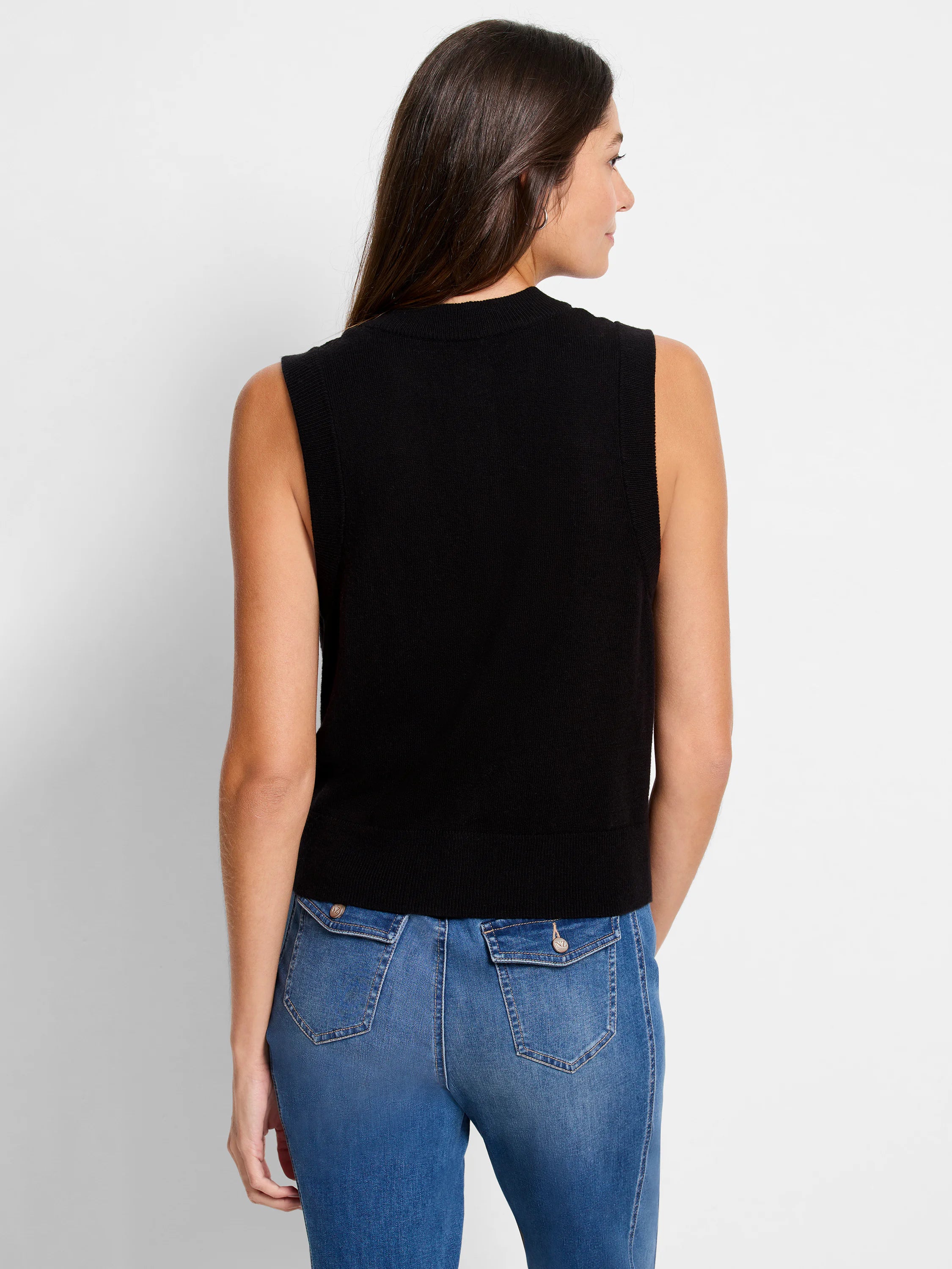 Black sleeveless sweater vest with a high mock neck and ribbed hem, shown from behind on a model.