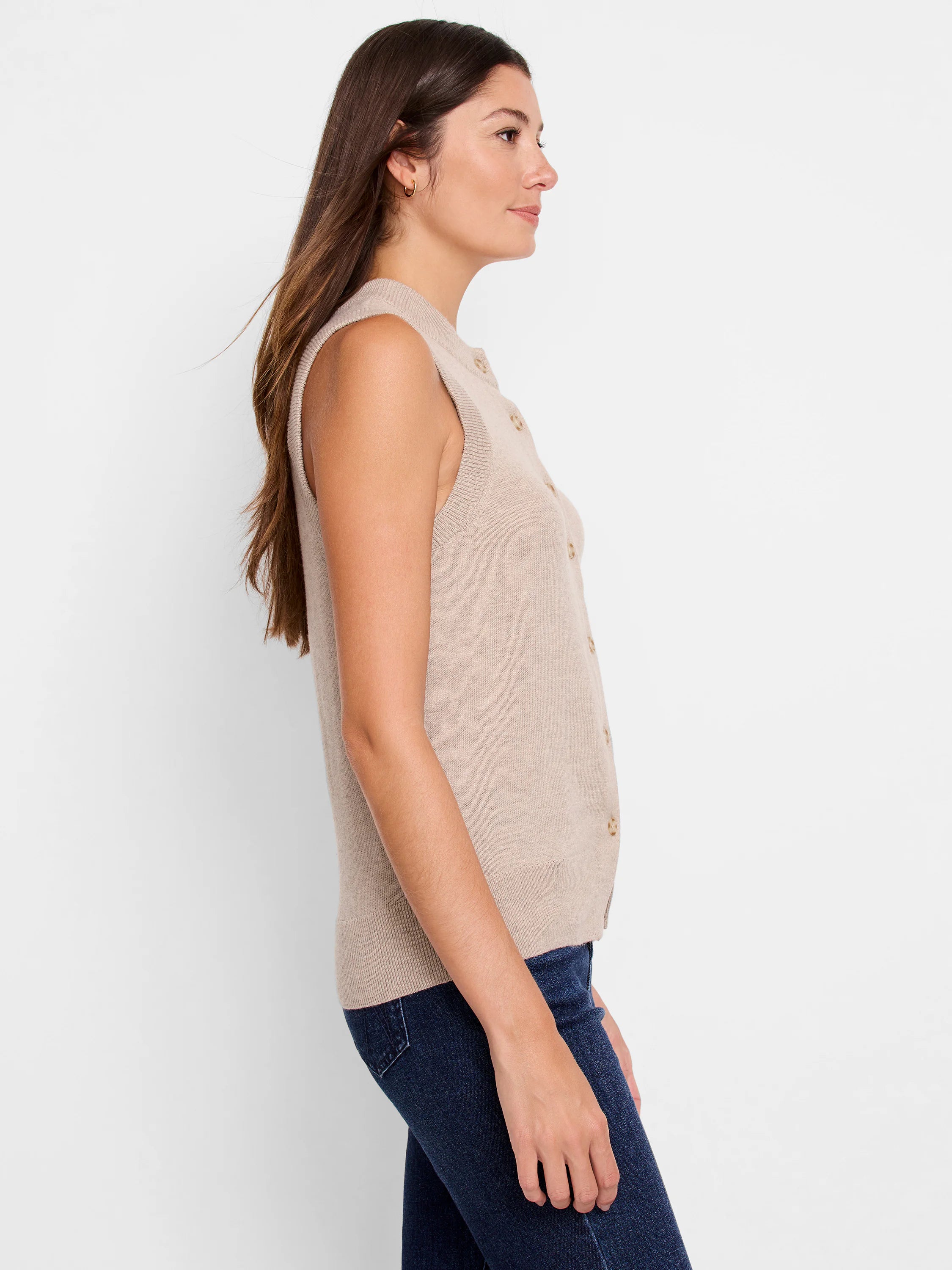 Light beige knit sweater vest. Sleeveless, button-front with ribbed armholes and hem.