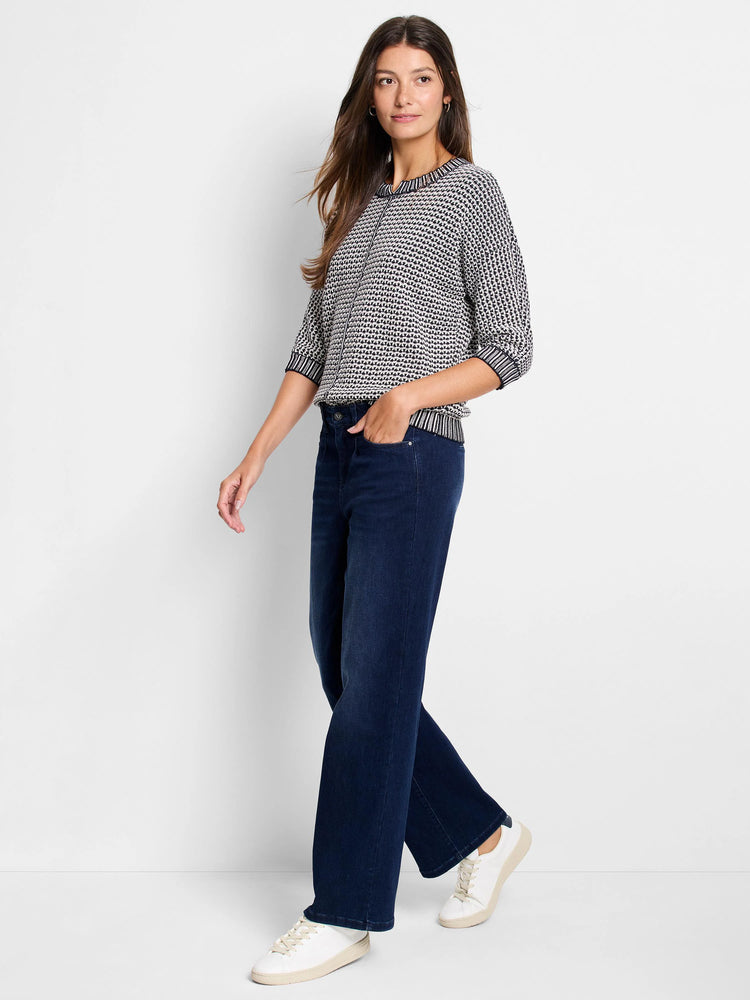 Black and white geometric tuck stitch sweater with 3/4 sleeves, a crew neck, and ribbed cuffs and hem.