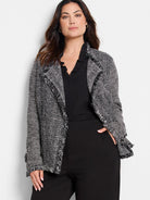 Black & white mixed knit jacket with chevron pattern and fringe trim.