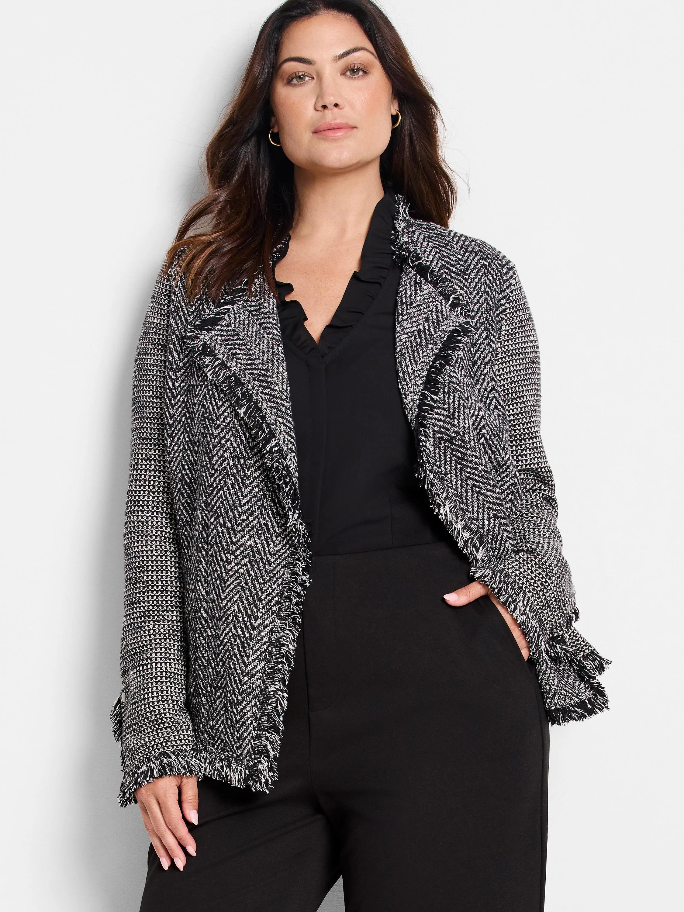 Black & white mixed knit jacket with chevron pattern and fringe trim.