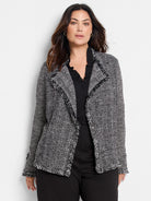 Black & white mix knit jacket with fringe on the lapels, hem, and cuffs.