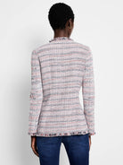 Plaid knit jacket with white, pink, and navy yarns, featuring fringe trim at the neck and hem.