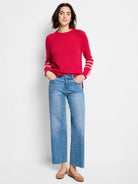 Bright pink sweater with white dashed stitching along raglan sleeves and cuffs.