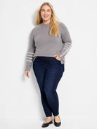 Grey crew neck sweater with white horizontal stripes and a white stitch pattern on sleeves.